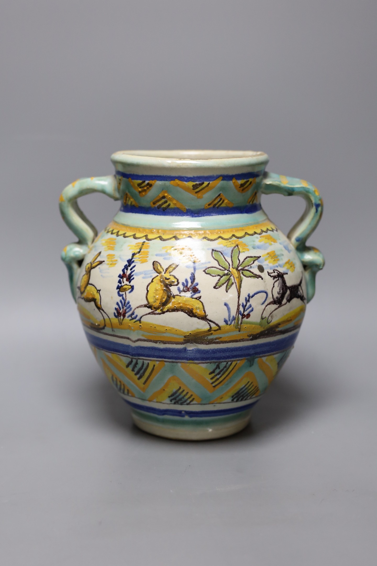 A maiolica vase decorated with hares, 23cm tall